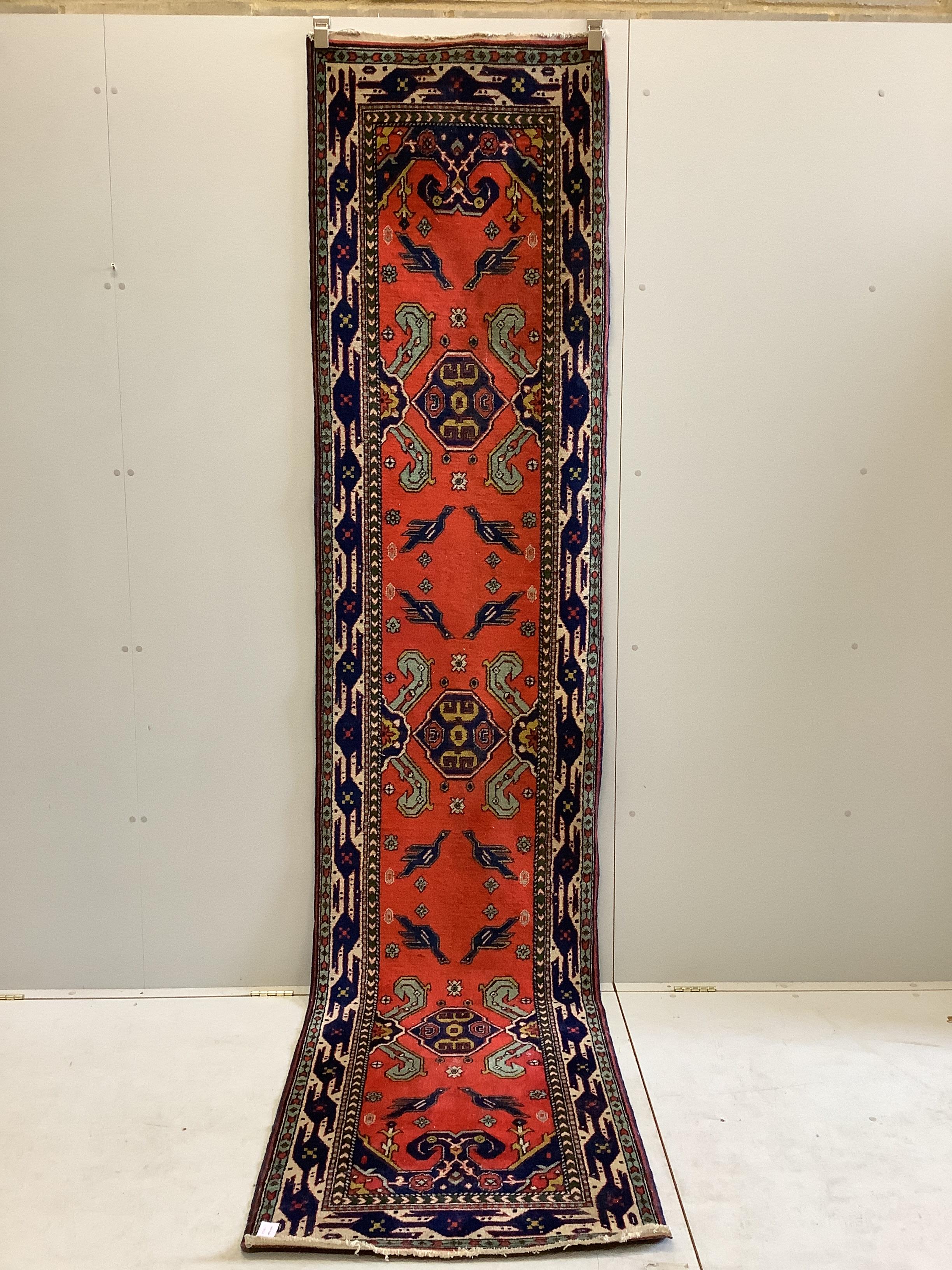 A Turkish red ground runner, 330 x 74cm